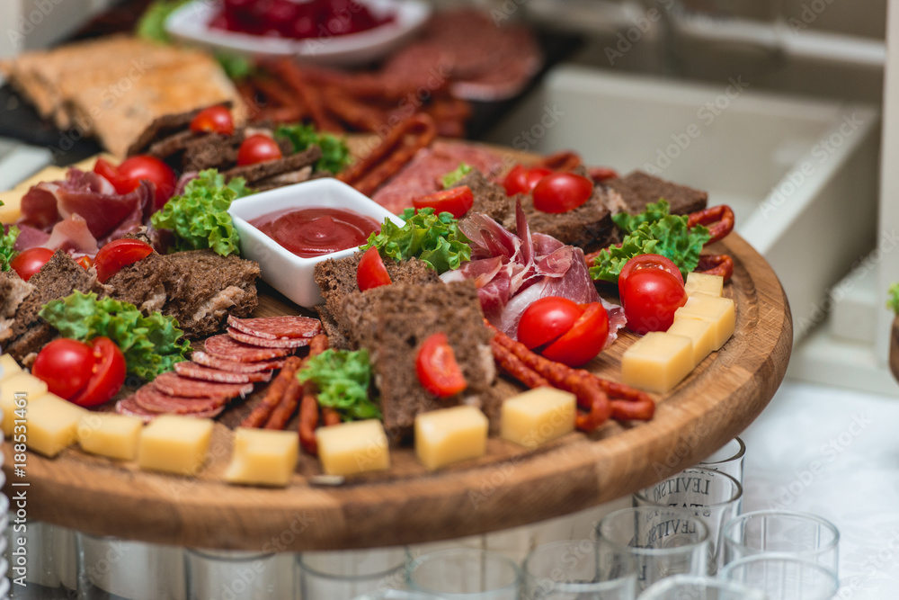 Mix cheese on wooden board with meat and bread