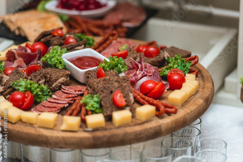 Mix cheese on wooden board with meat and bread