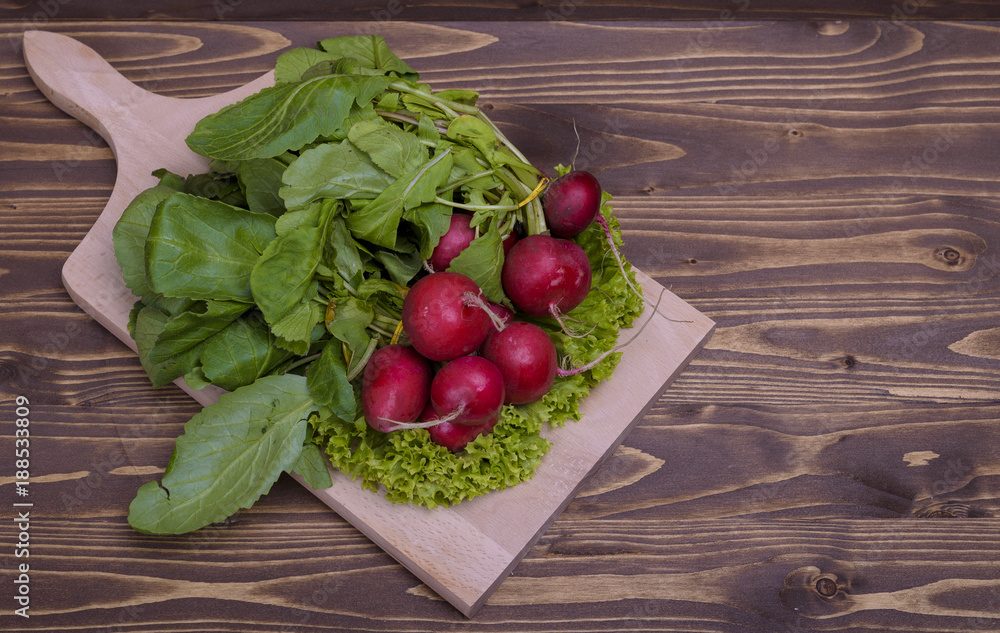 bunch of radishes on a wooden board bunch of radishes on a wooden board