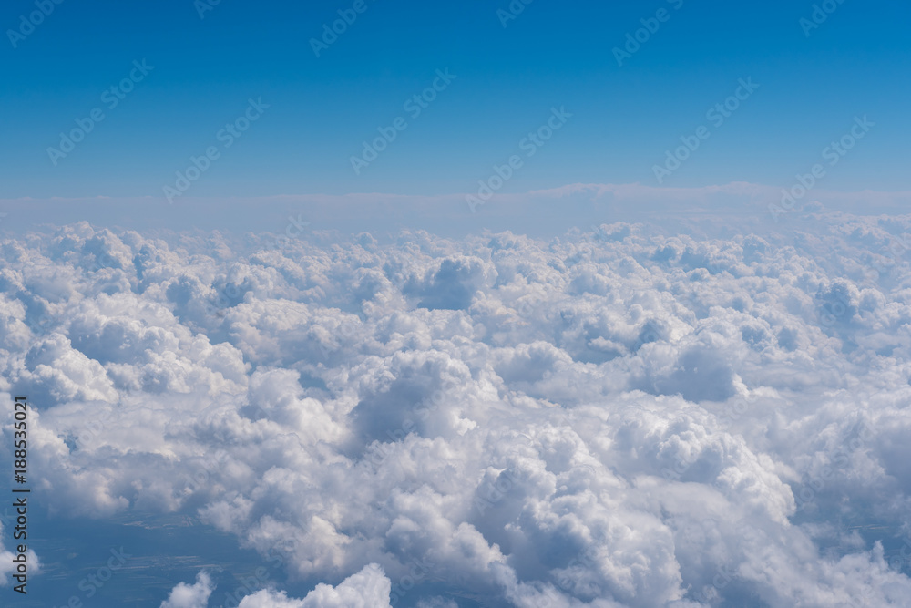 Blue sky and clouds, view from airplane window. Nature background, aerial view. Blue sky and clouds, view from airplane window. Nature background, aerial view.
