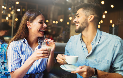 Young attractive couple on date in coffee shop photo