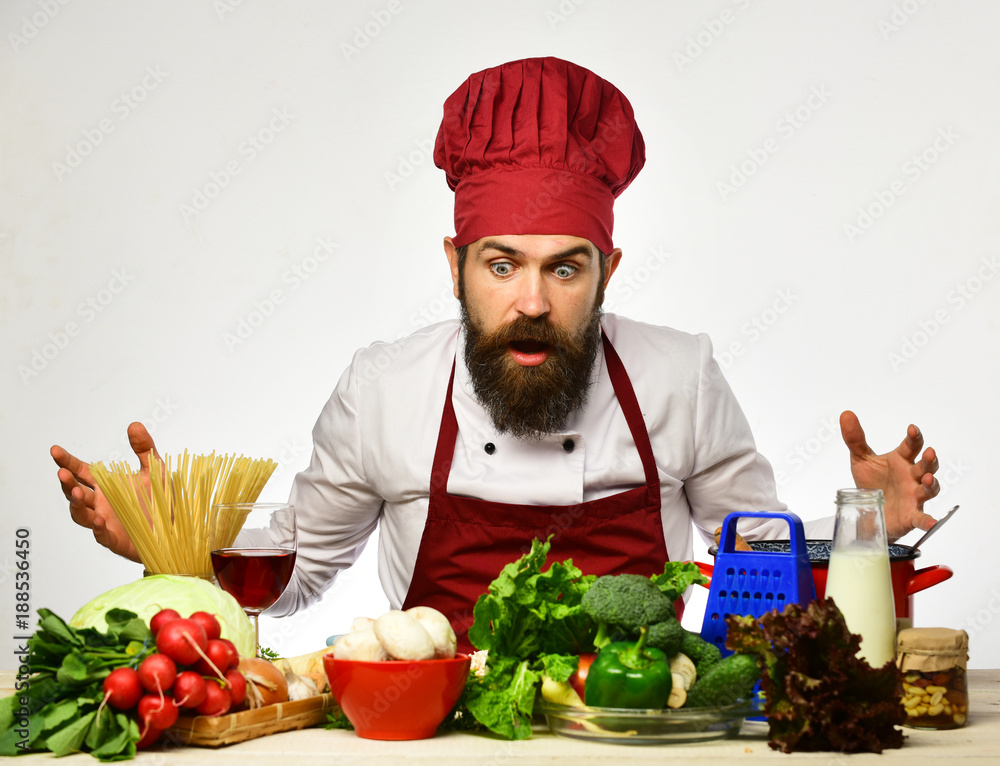 Cooking process concept. Man with beard looks at ingredients Cooking process concept. Man with beard looks at ingredients