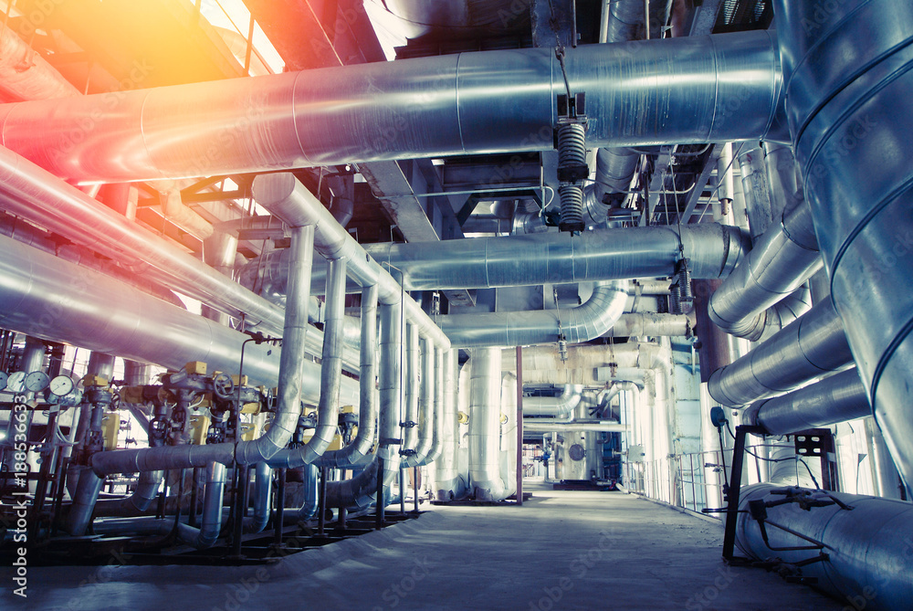 Equipment, cables and piping as found inside of a modern industrial power plant Equipment, cables and piping as found inside of a modern industrial power plant