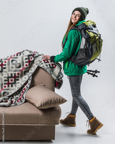 beautiful femele hiker with backpack at sofa with plaid photo