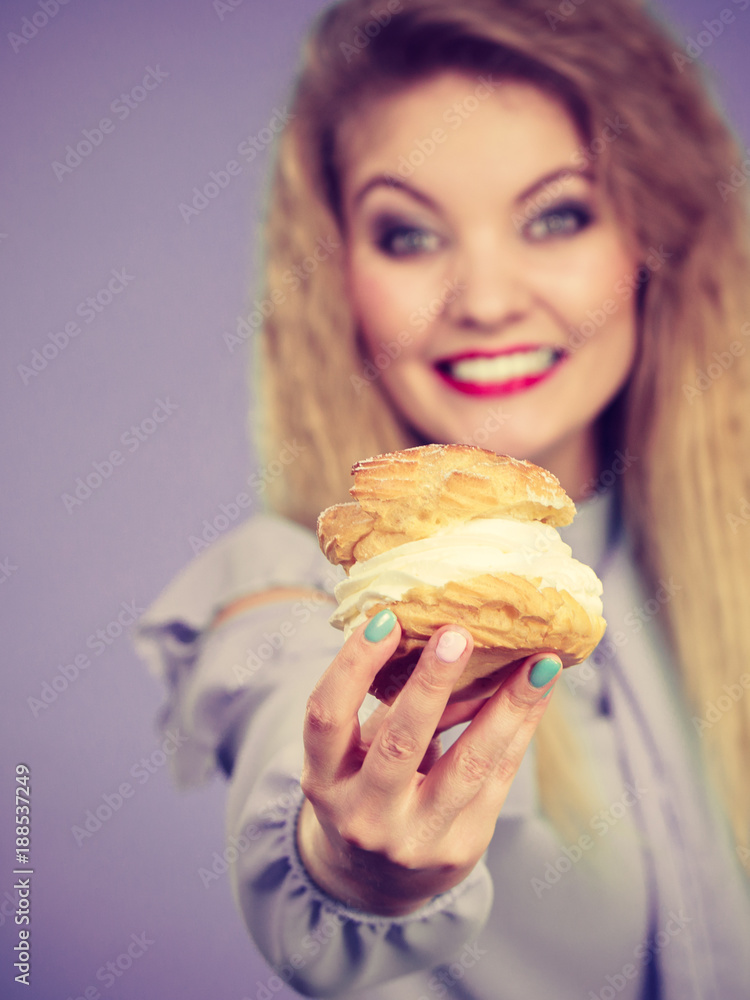 Funny woman holds cream puff cake Funny woman holds cream puff cake