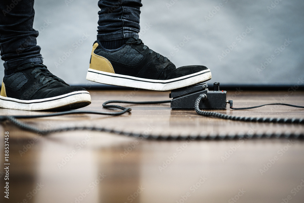 Fototapeta premium Man using guitar effects pedal