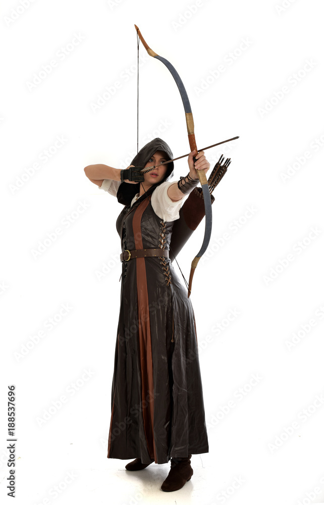 full length portrait of girl wearing brown fantasy costume, holding a bow and arrow, on white studio background. full length portrait of girl wearing brown fantasy costume, holding a bow and arrow, on white studio background.