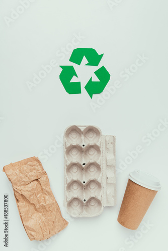 flat lay with recycle sign and disposable trash isolated on grey