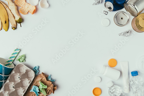 flat lay with arranged different types of garbage isolated on grey