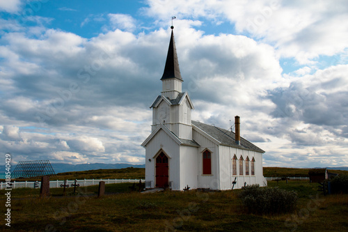 White wooden church with graveyard in Finnmark