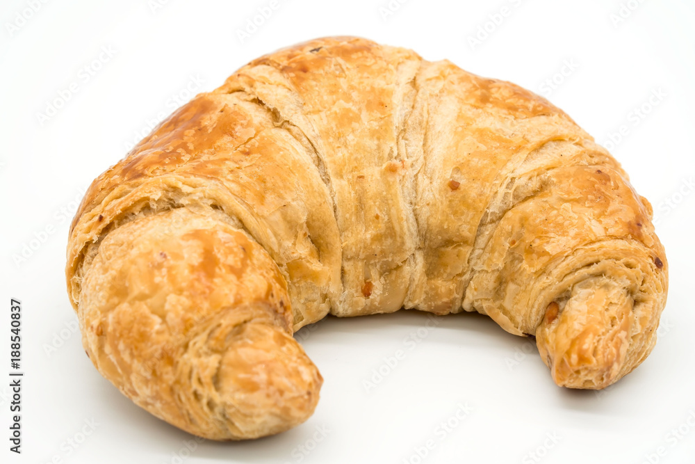 Fresh croissant isolated on a white background closeup .