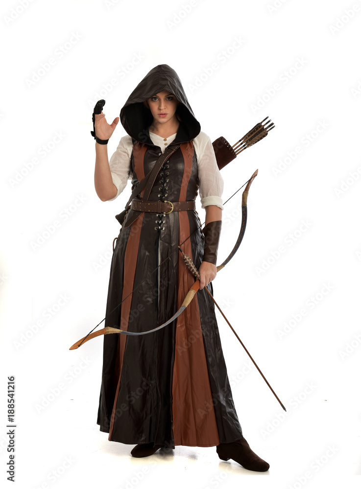 full length portrait of girl wearing brown fantasy costume, holding a bow and arrow, on white studio background. full length portrait of girl wearing brown fantasy costume, holding a bow and arrow, on white studio background.