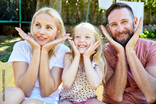 Portrait of happy family pulling the same face