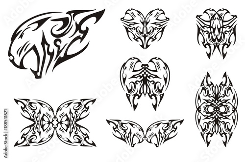 Fototapeta Naklejka Na Ścianę i Meble -  Tribal aggressive tiger head symbols. The growling head of a tiger can be used as a tattoo, double decorative symbols, similar to butterflies, formed from her. Black on white