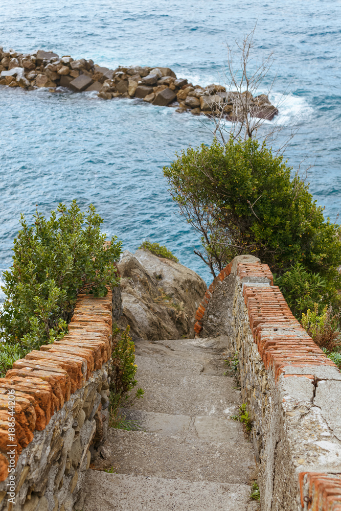 old stairs and beautiful seascape with stones in Riomaggiore, Italy