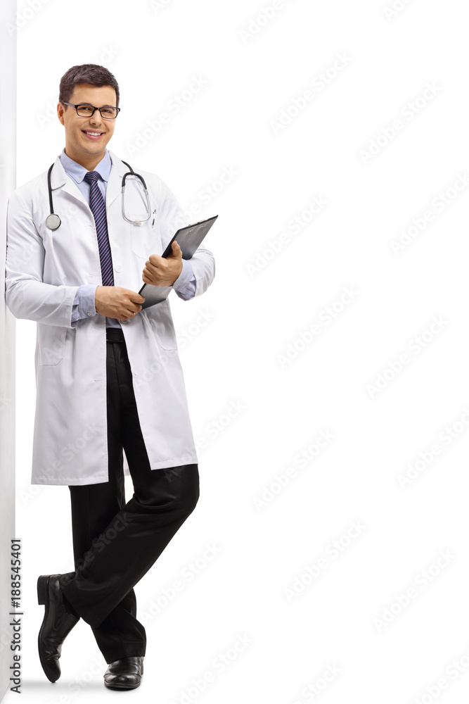 Doctor with a clipboard leaning against a wall Doctor with a clipboard leaning against a wall