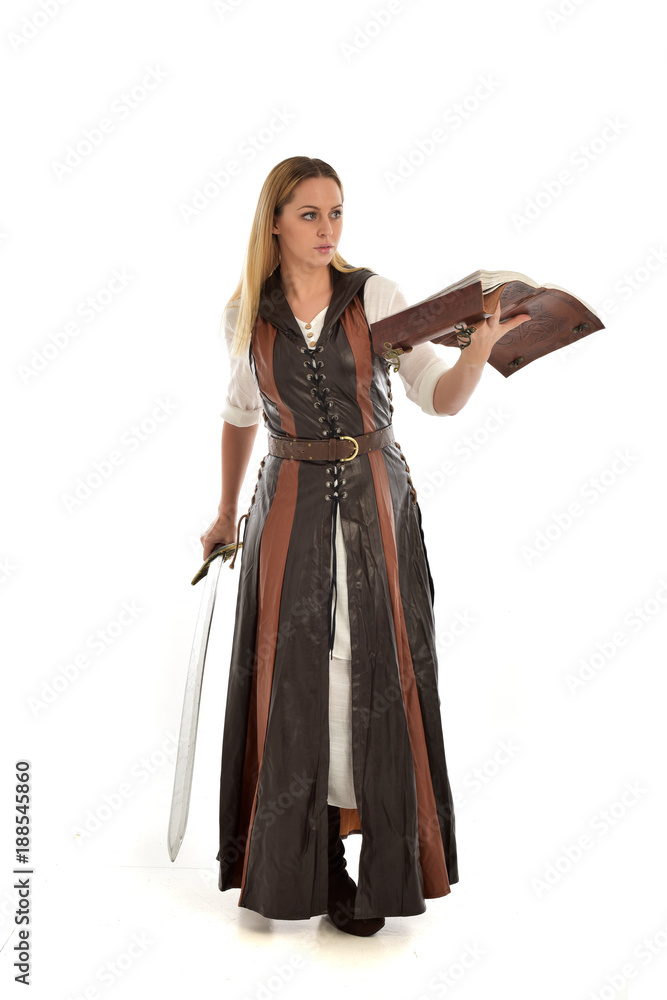 full length portrait of girl wearing brown fantasy costume, holding a sword. standing pose on white studio background. full length portrait of girl wearing brown fantasy costume, holding a sword. standing pose on white studio background.