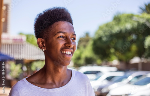 Young African Male on the streets of Johannesburg, South Africa, with cool street clothing and table top afro hairstyle.