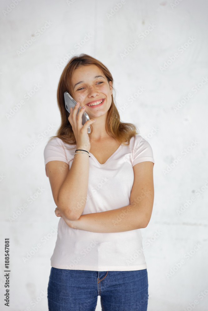 Beautiful female teenager talking with smartphone, isolated on white background Beautiful female teenager talking with smartphone, isolated on white background
