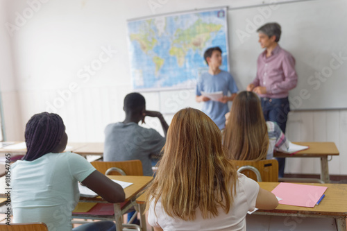 Teenager interviewed by teacher in the classroom