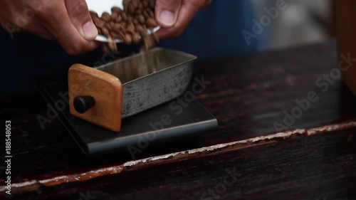 Barista weighs the coffee beans. Process Weighing freshly coffee. Close up.