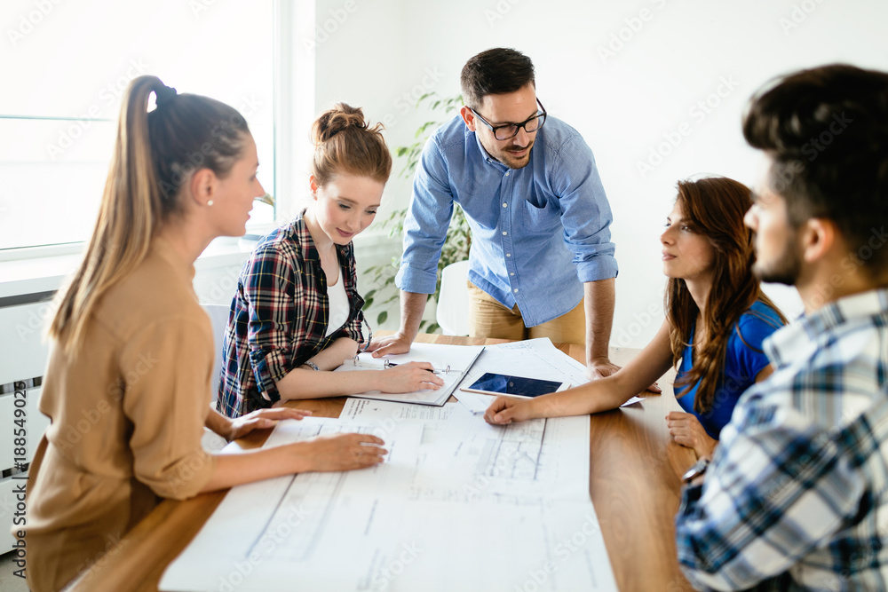 Image of business partners discussing documents and ideas Image of business partners discussing documents and ideas
