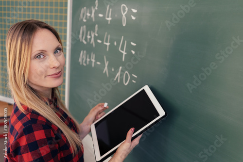 Dedicated teacher holding a tablet during class photo