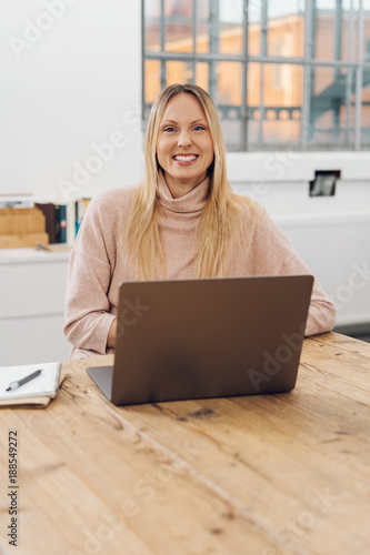 Friendly blond businesswoman with a big smile