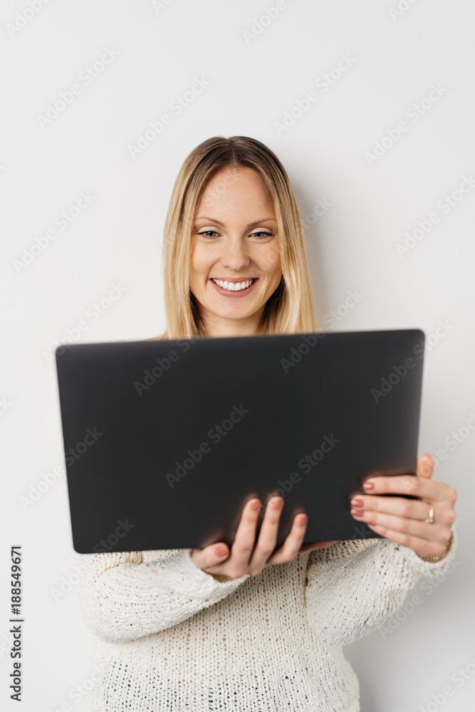 Blonde smiling woman using laptop Blonde smiling woman using laptop