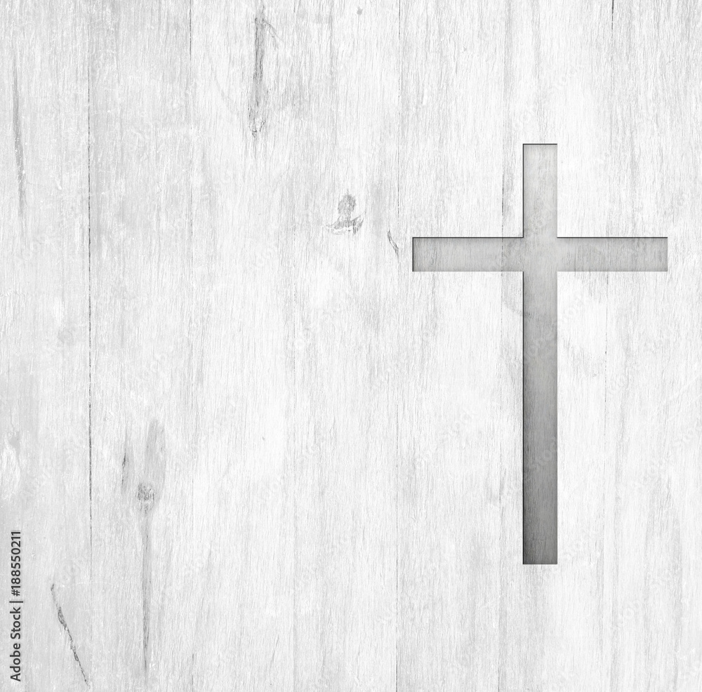 White old christian religion symbol cross shape as sign of belief on a grungy wood textured