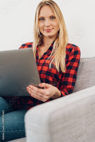 Relaxed friendly woman using a laptop at home