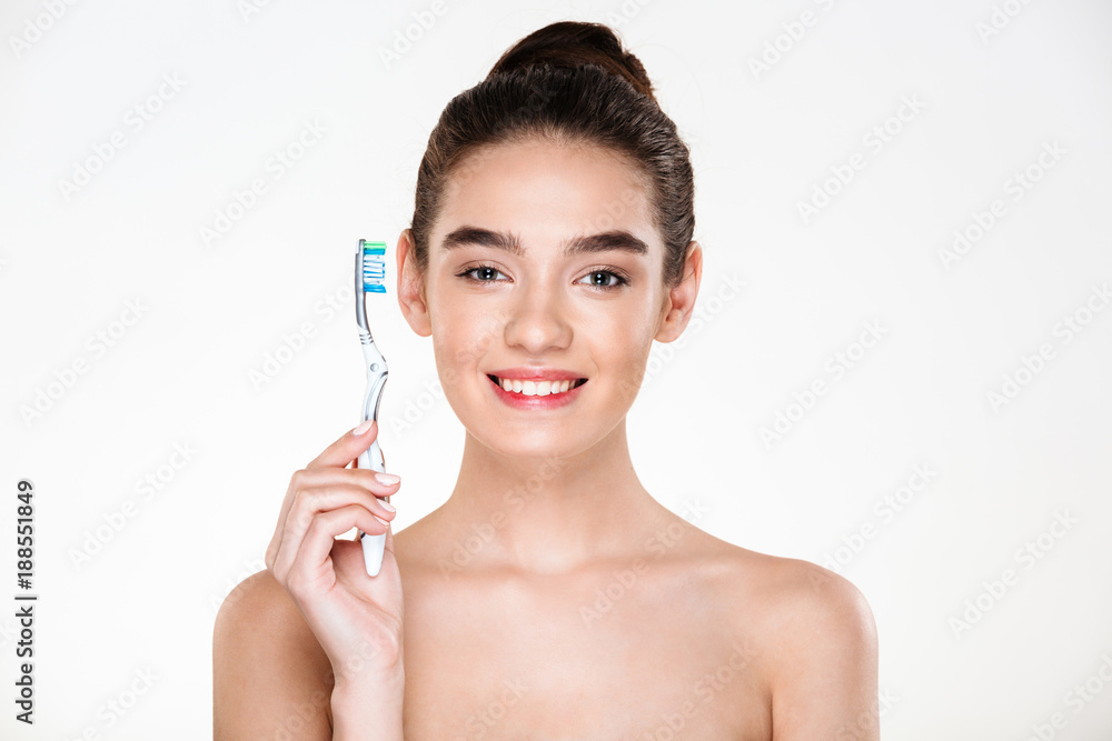 Dental hygiene and body care of healthy pretty woman posing on camera with toothbrush isolated over white background