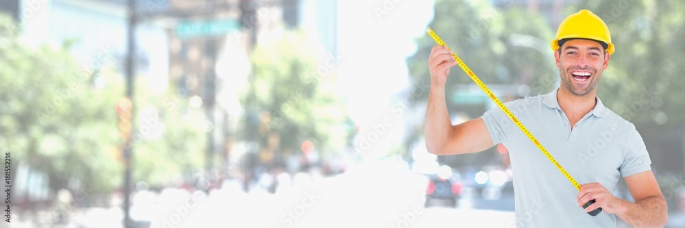 Construction Worker on building site holding measuring tape Construction Worker on building site holding measuring tape
