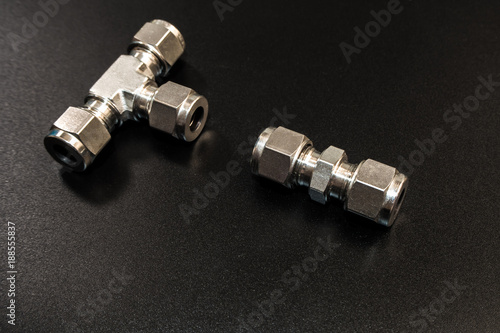 Fotografía The Stainless steel joint fitting of pneumatic system on black background