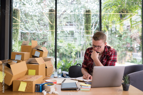 frustrated startup small business owner working at workplace. stressed freelance man seller check product order for delivery.  Online selling, e-commerce, shipping concept
