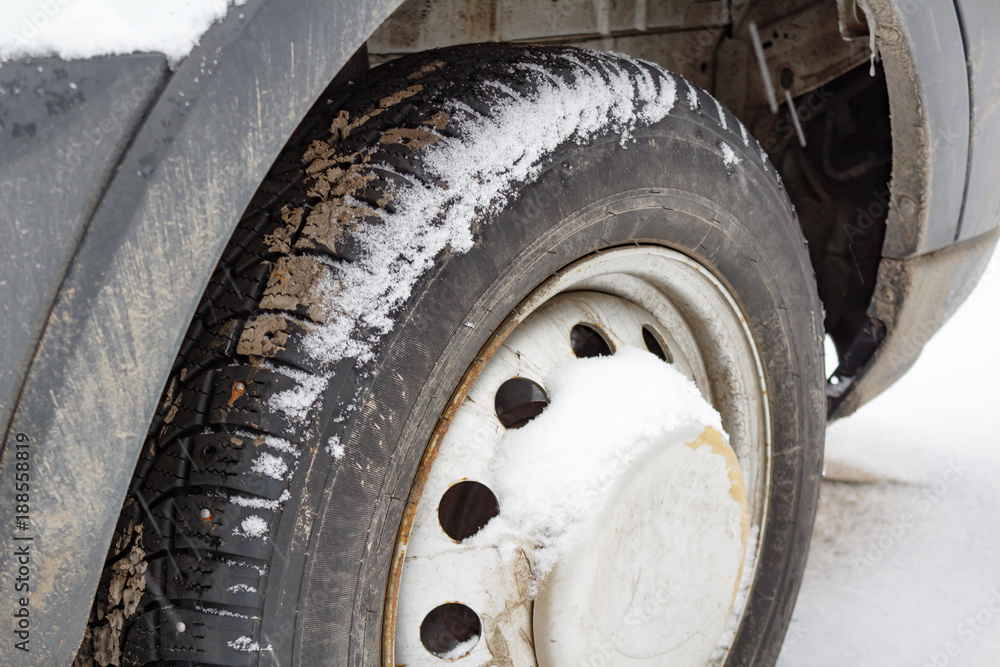 Front wheel of the truck covered with snow closeup Front wheel of the truck covered with snow closeup