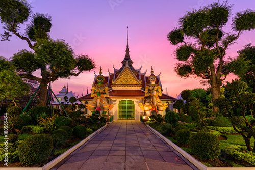 Bangkok , Thailand - 15 January, 2018: giant statue at white pagoda in Wat Arun Ratchawararam Ratchawaramahawihan in sunset time