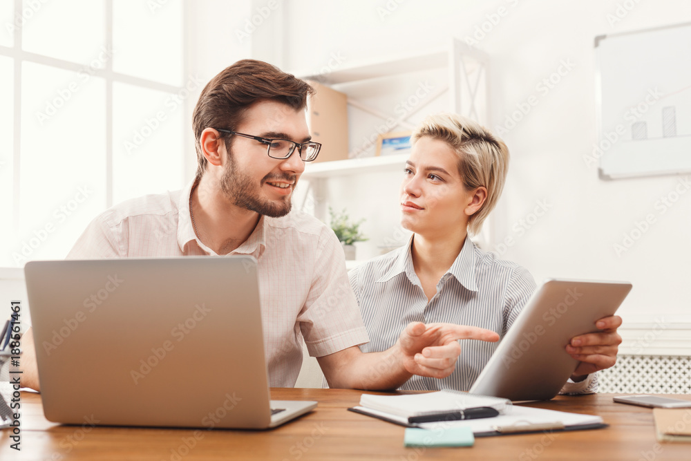 Couple of young business partners working at modern office Couple of young business partners working at modern office