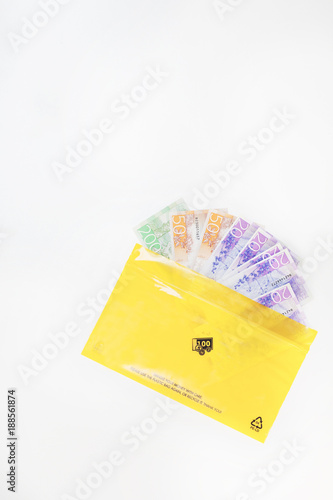 Yellow envelope with banknotes sticking out photo