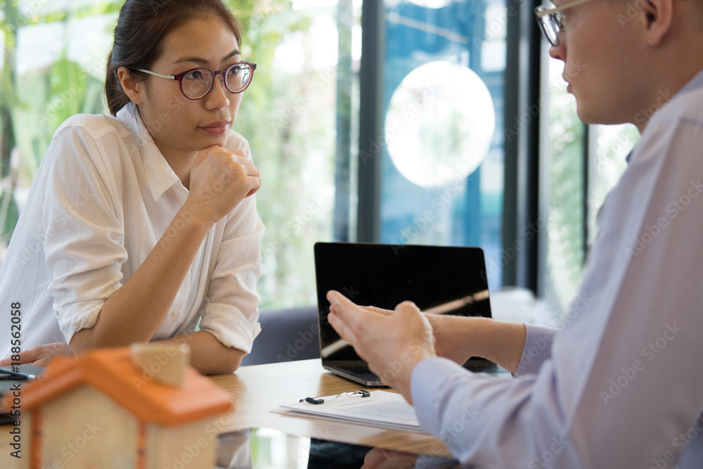 realtor talk with client. real estate agent have a meeting with customer. sale & purchase property with house model & signing contract document