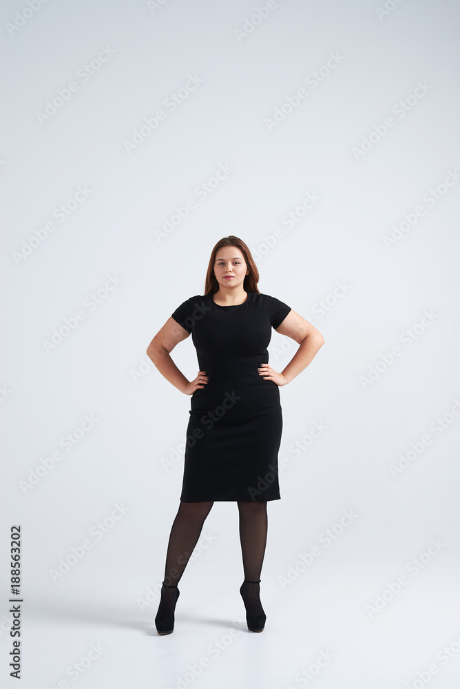 Beautiful girl in fashionable dress posing at studio Beautiful girl in fashionable dress posing at studio