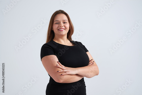 Smiling woman standing with folded hands
