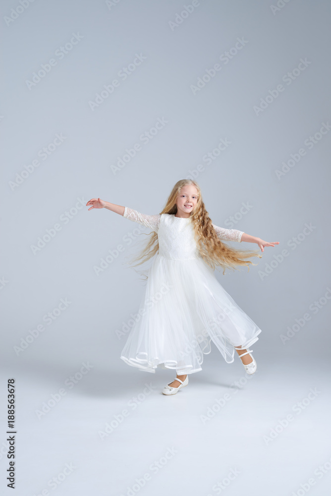 Cute blonde girl in white dress dancing at studio Cute blonde girl in white dress dancing at studio