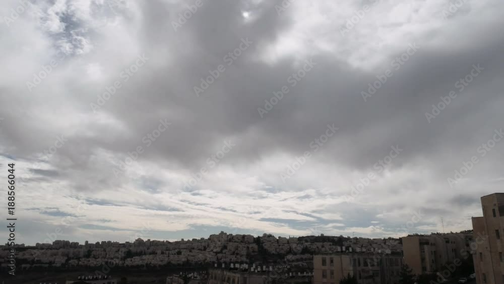 Clouds are moving over the roofs of the residential area in Jerusalem. Timelapse. Clouds are moving over the roofs of the residential area in Jerusalem. Timelapse.