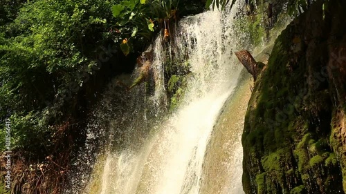 Waterfall at Kwae Noi river. Beautiful green forest. Sai Yok National Park, Kanchanaburi, Thailand. Travel to Asia. photo