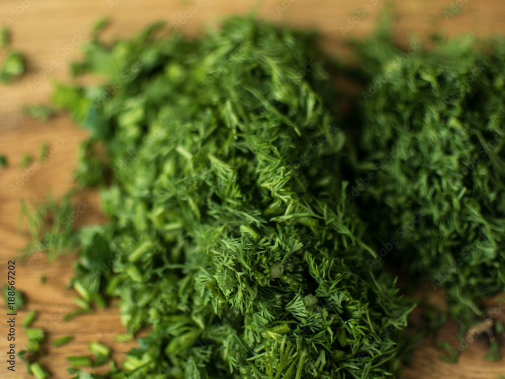 finely chopped greens on a chopping board. finely chopped greens on a chopping board.