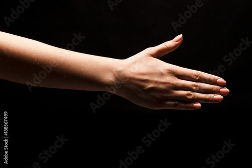 Hand ready for handshake isolated on black