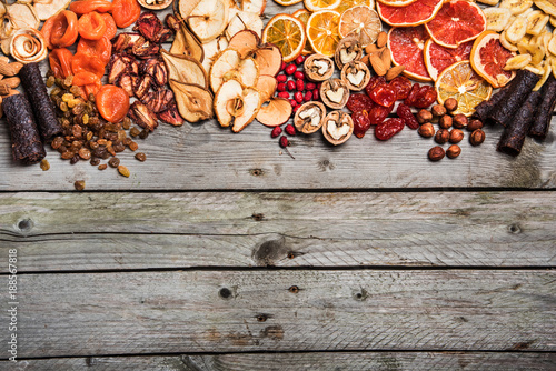 Fototapeta Naklejka Na Ścianę i Meble -  Different dried fruits on a wooden surface