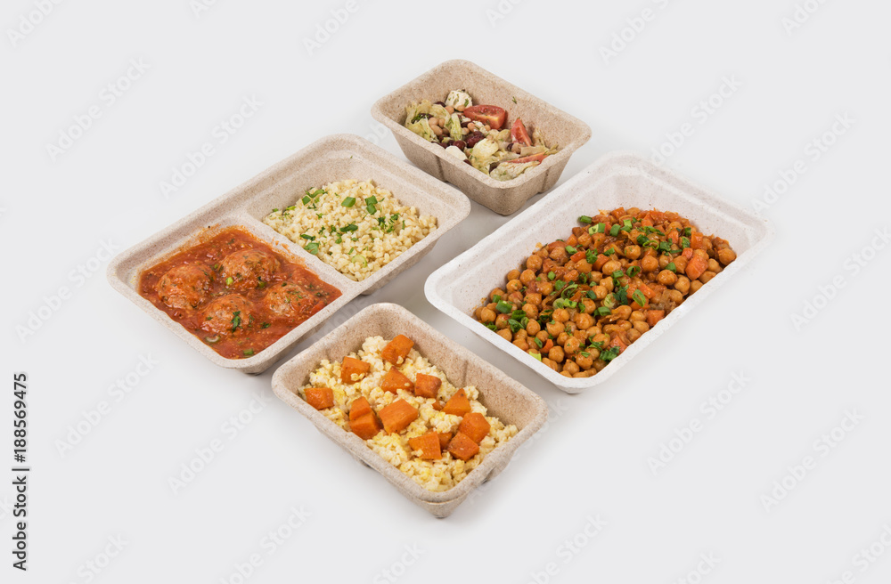 Healthy food delivery for fitness nutrition or diet. Daily meals in paper boxes on a white background