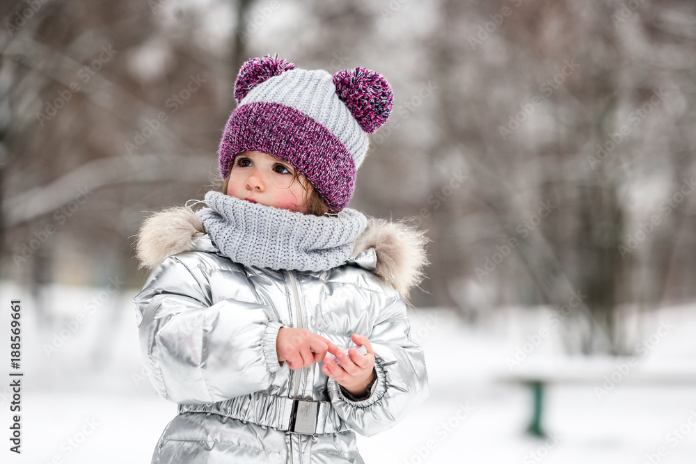 Little girl having fun at winter.